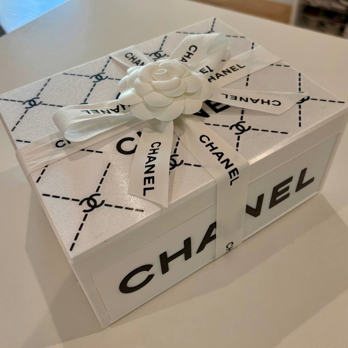 White 3D-printed keepsake box with a quilted pattern, ribbon, and camellia flower, made by Jill