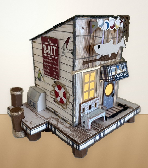 Bait House SVG craft with weathered wood siding, bait sign, porch bench, fish decorations, and lit yellow windows